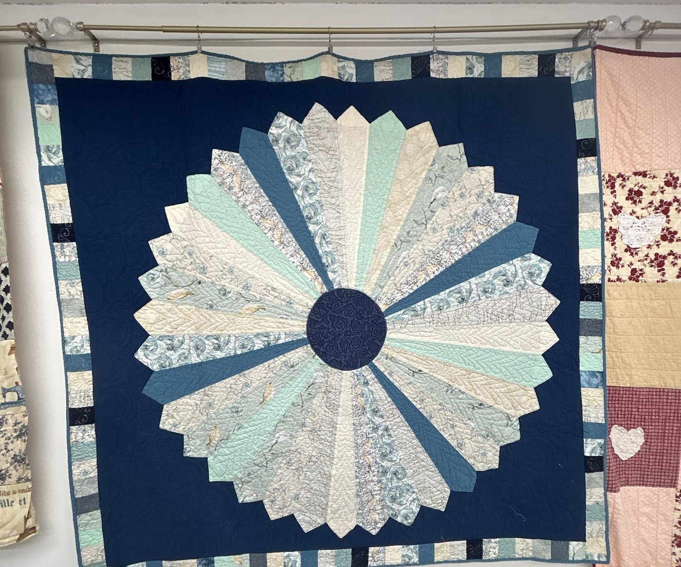 The Dresden plate quilt hanging in the studio