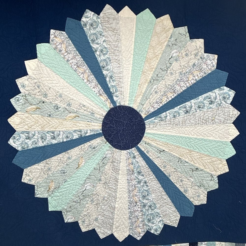 The Dresden plate quilt: twenty wedges in cream, sea green, pale blue florals and slate on a navy ground